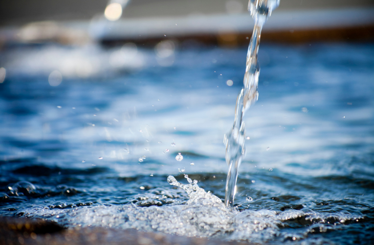 Water surface and two spurts splashing on it